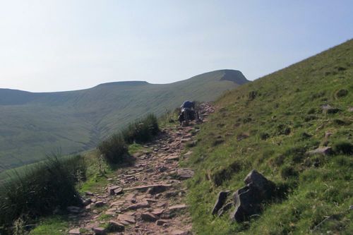 one-off handcycle climbing a steep, rough trail